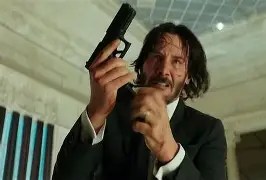 John Wick holding a gun