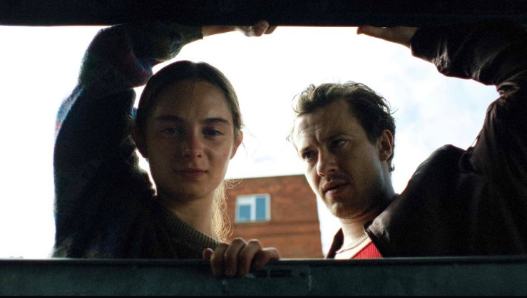 Maria and Michael are looking down at something that is out of shot
